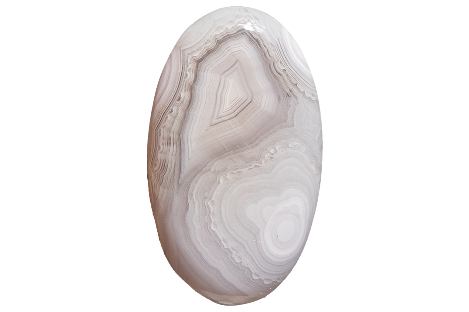 An oval polished agate cabochon with concentric banding in soft white, beige, and light gray tones, isolated on a plain white background.