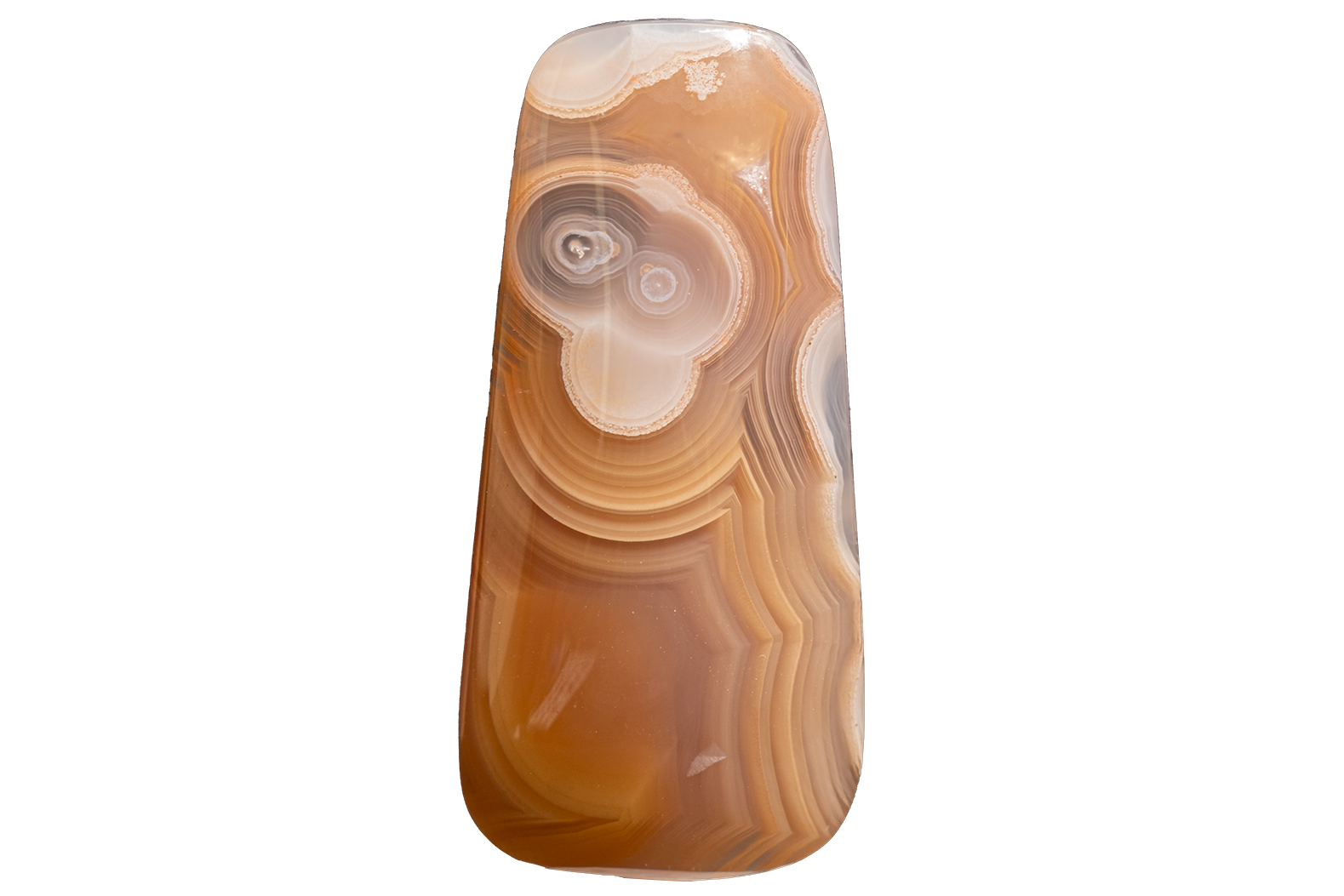 A polished agate stone pendant with concentric banding in shades of brown, tan, cream, and gray, isolated on a solid white background.