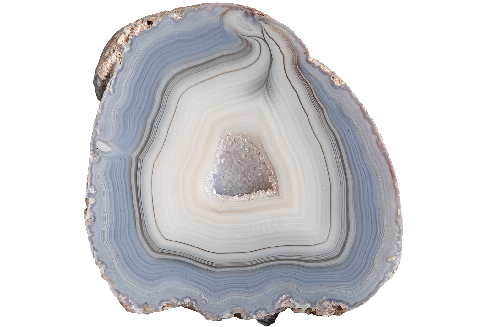 A polished cross-section of agate or jasper stone showing concentric bands of pale blue, gray, white, and black, with a small crystalline cone in the center, isolated on a white background.