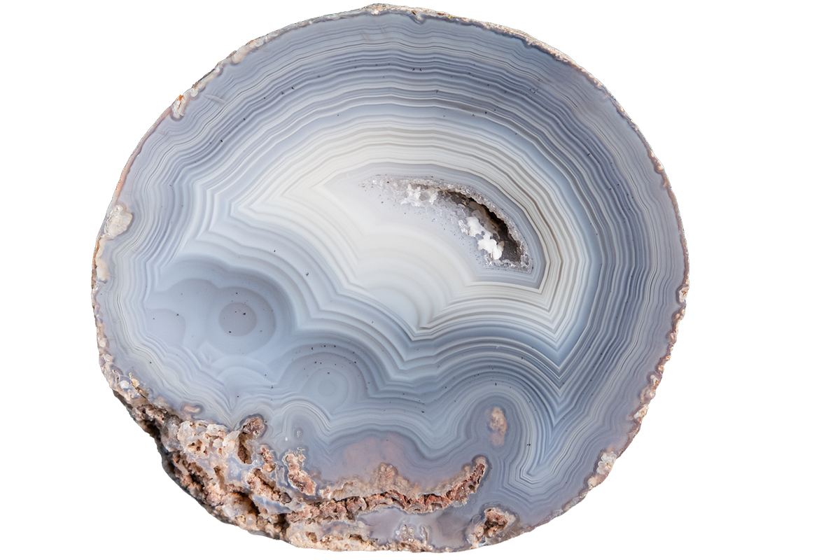 A polished slice of agate stone with concentric bands of light blue, white, gray, and brown, isolated on a solid white background.