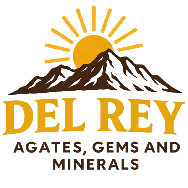 Logo of Del Rey Agates, Gems and Minerals with a mountain and sun design.